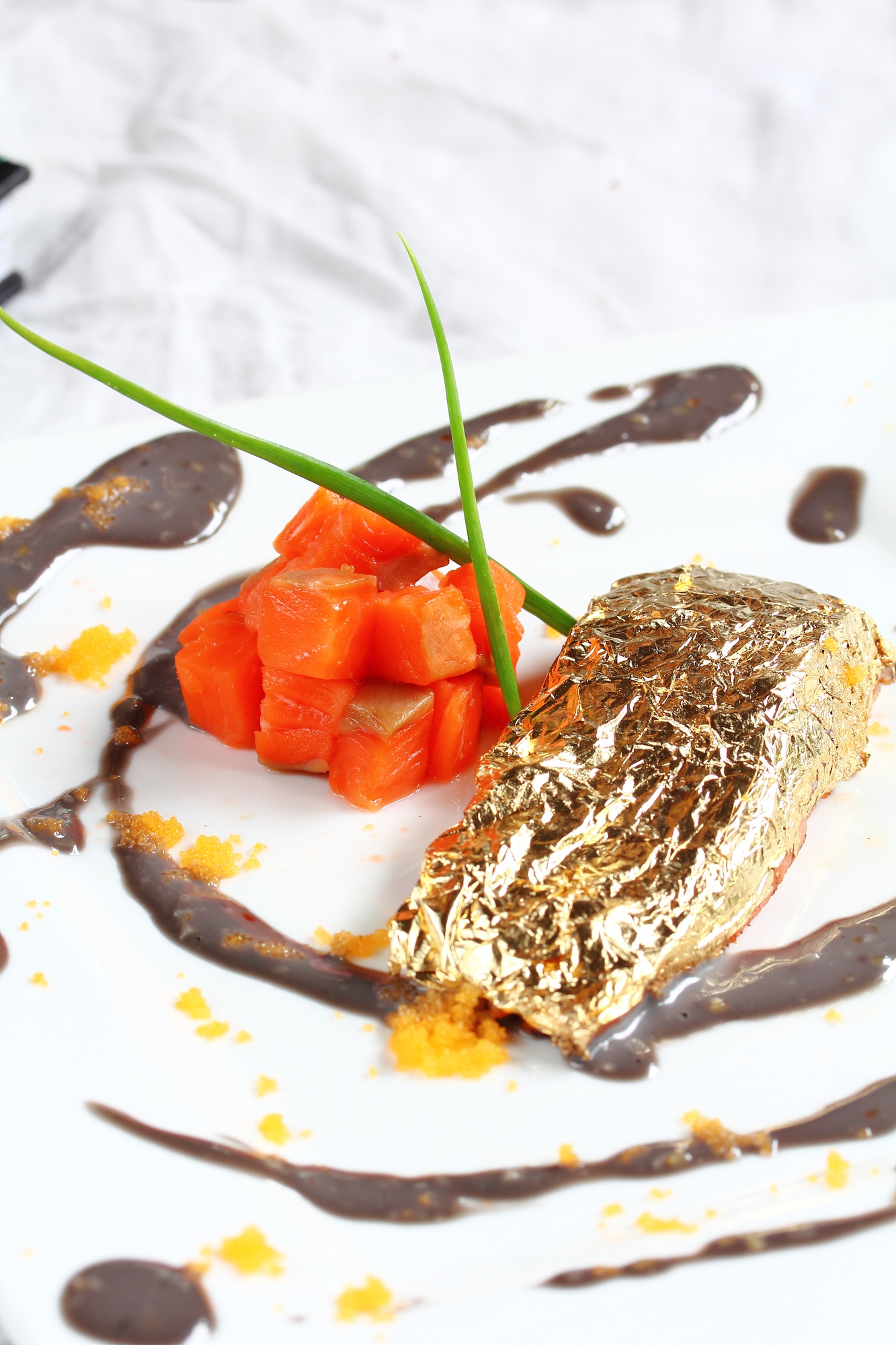 Close-up of layered dessert with gold leaf