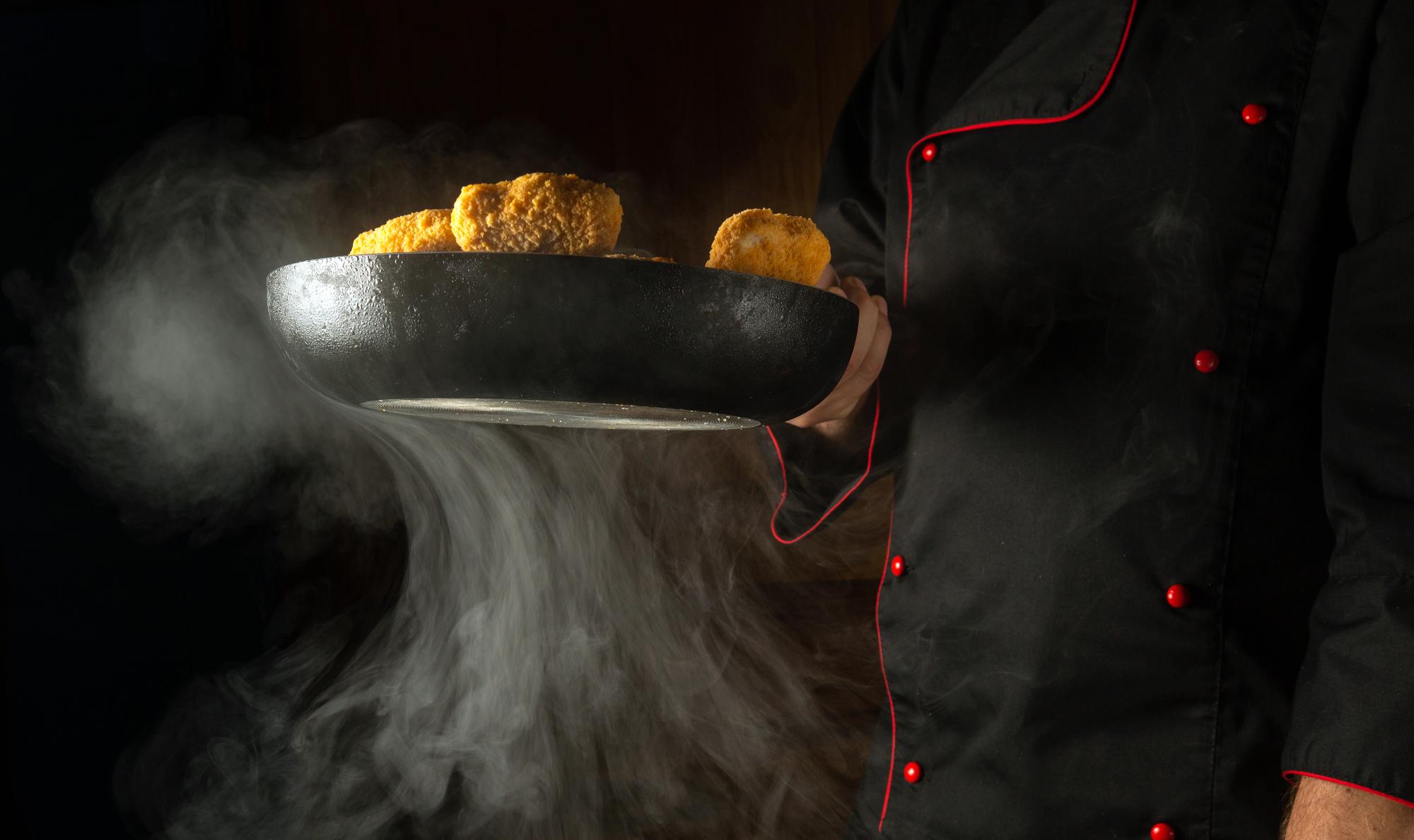 Chef finishing a smoky course