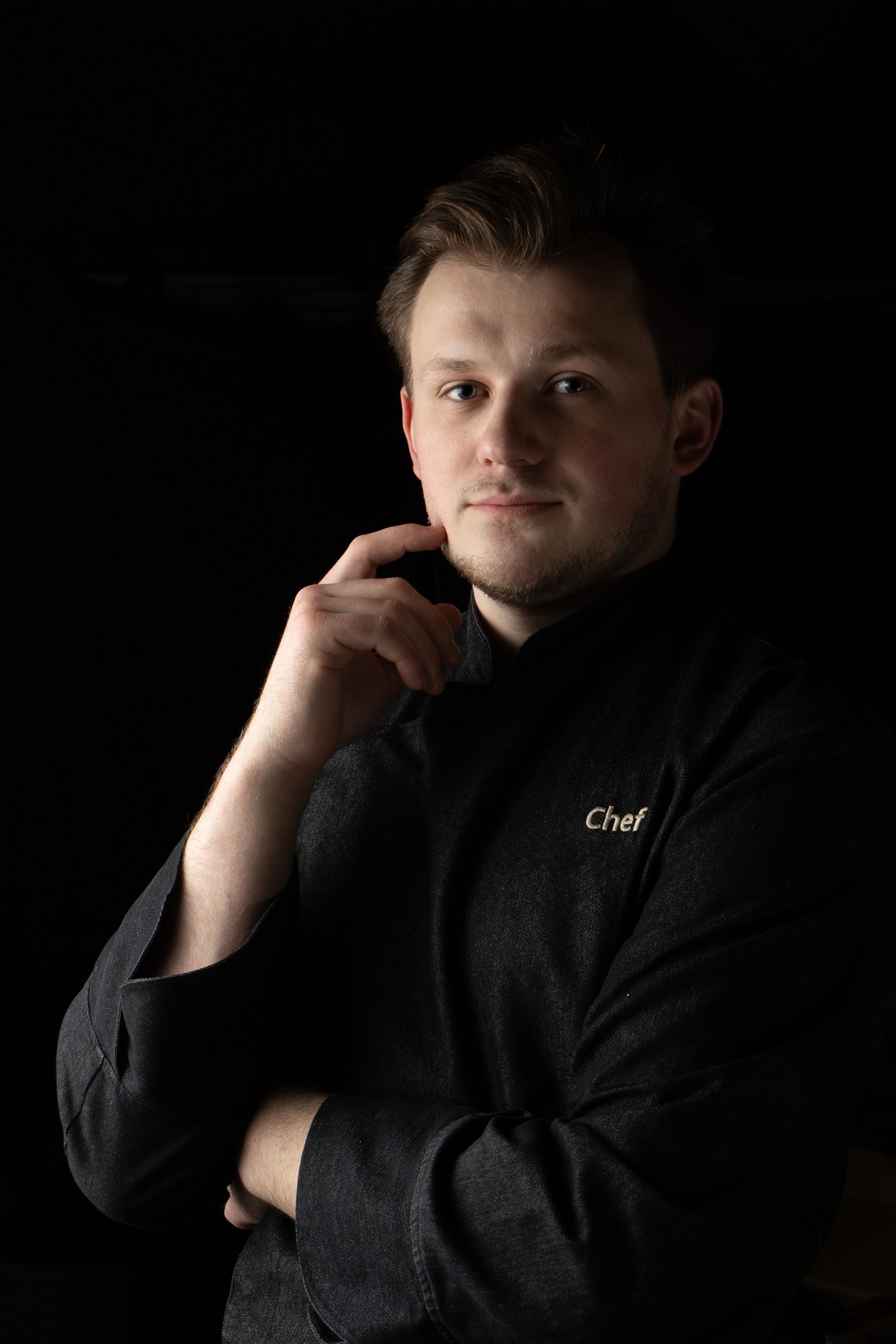 Portrait of head chef in dark uniform