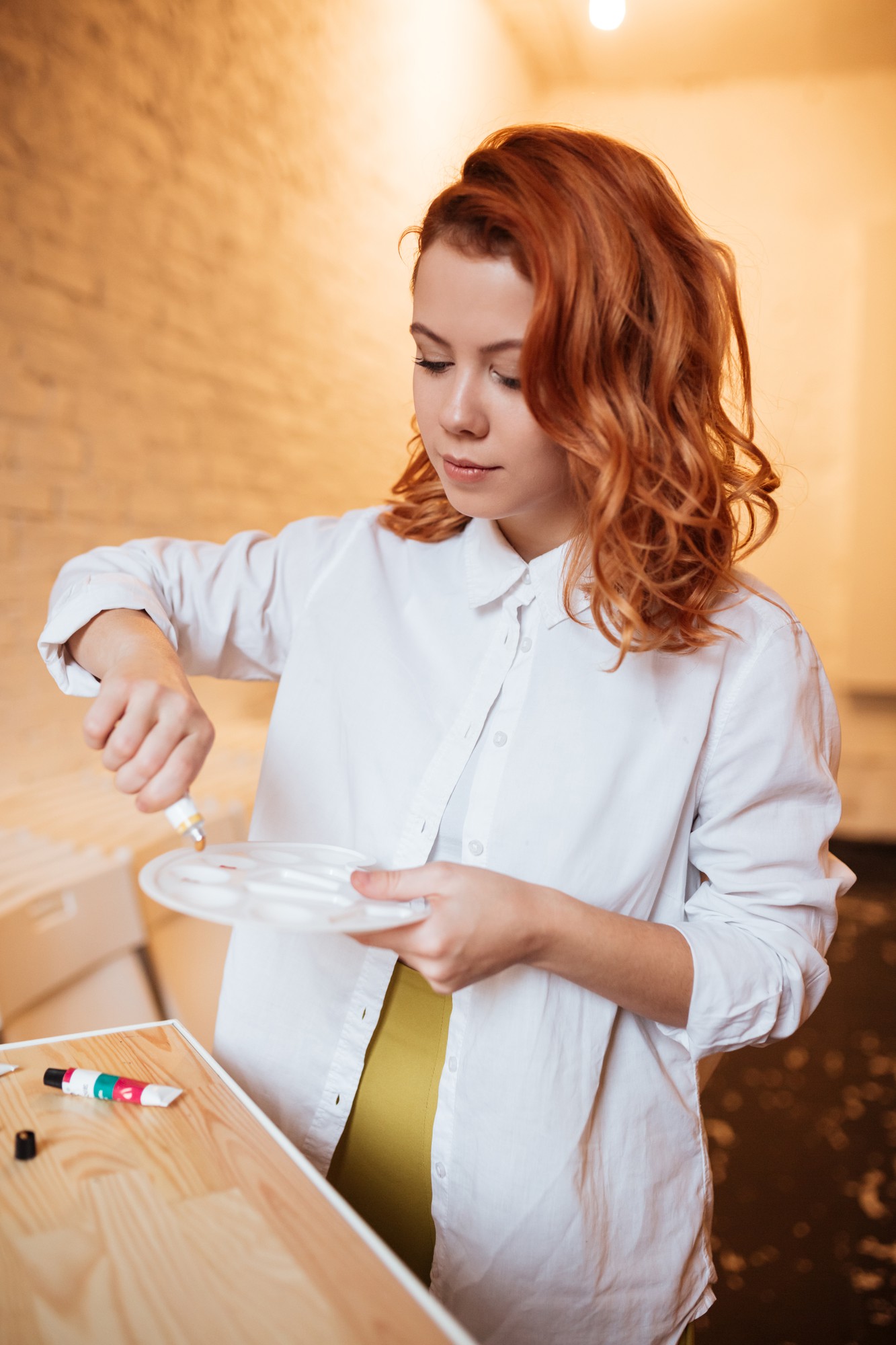 Portrait of operations lead arranging tableware